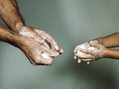 image of 2 people washing their hands